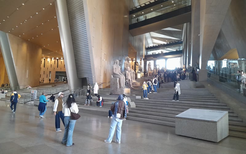 Exterior terraces and geometric stone facade of the Grand Egyptian Museum in Giza